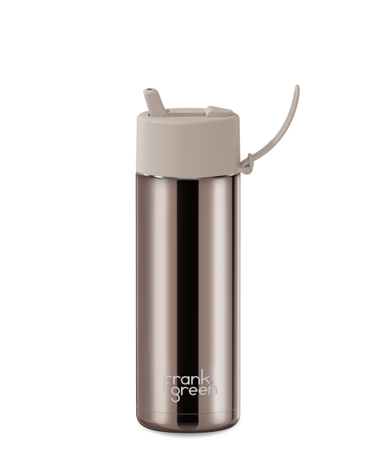 A stainless steel travel tumbler with a brushed metallic rose gold finish, featuring a light beige lid with a flip-up straw spout and a small carrying loop, on a solid white background.